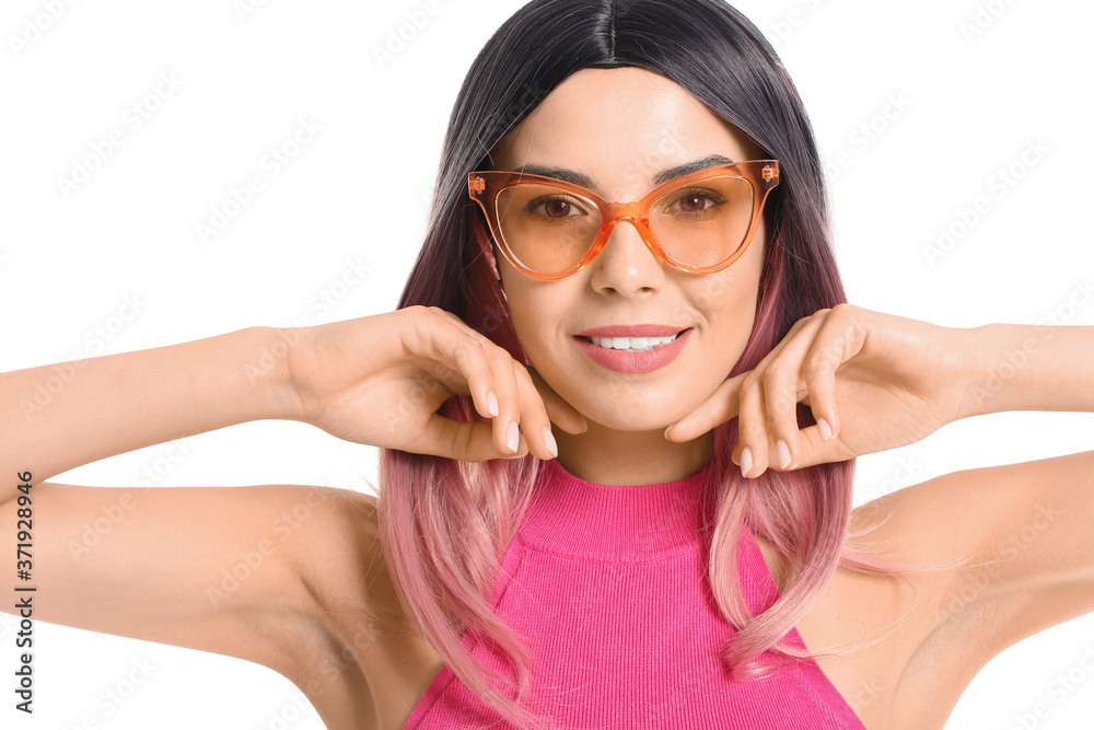 Beautiful young woman in wig on white background