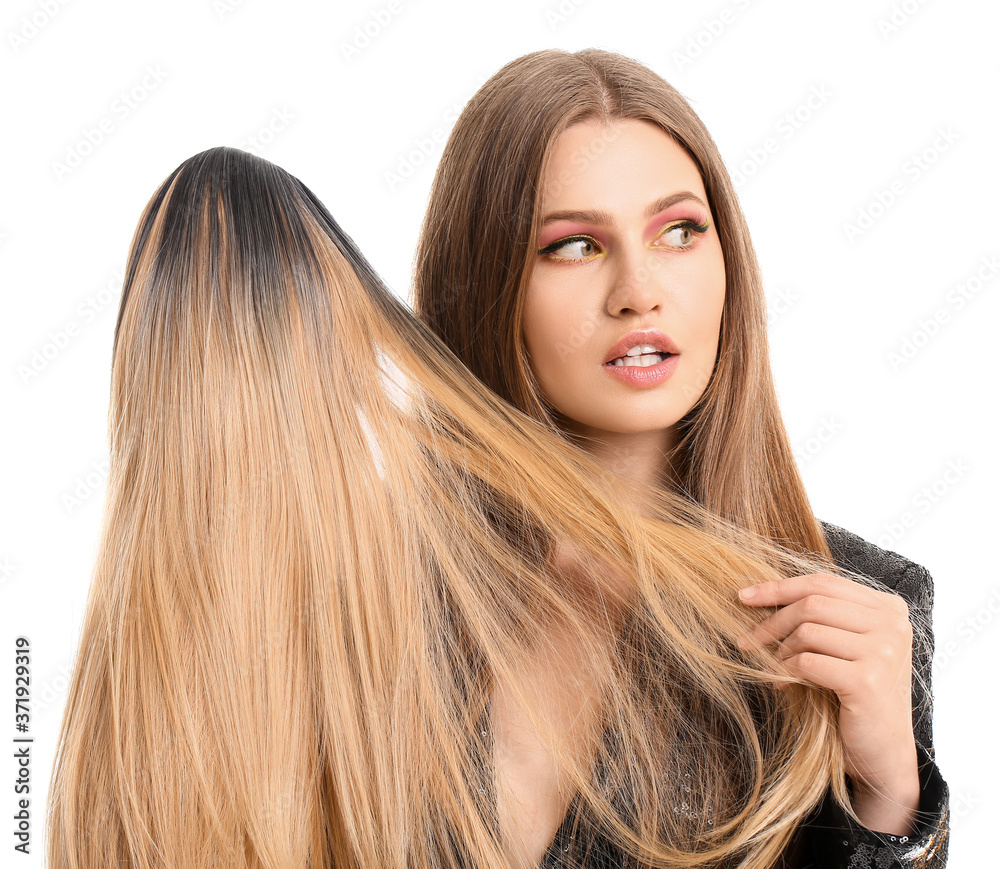 Beautiful young woman with wig on white background