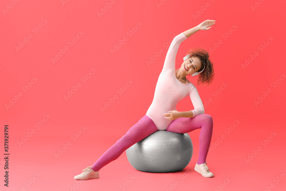 Young woman doing aerobics on color background