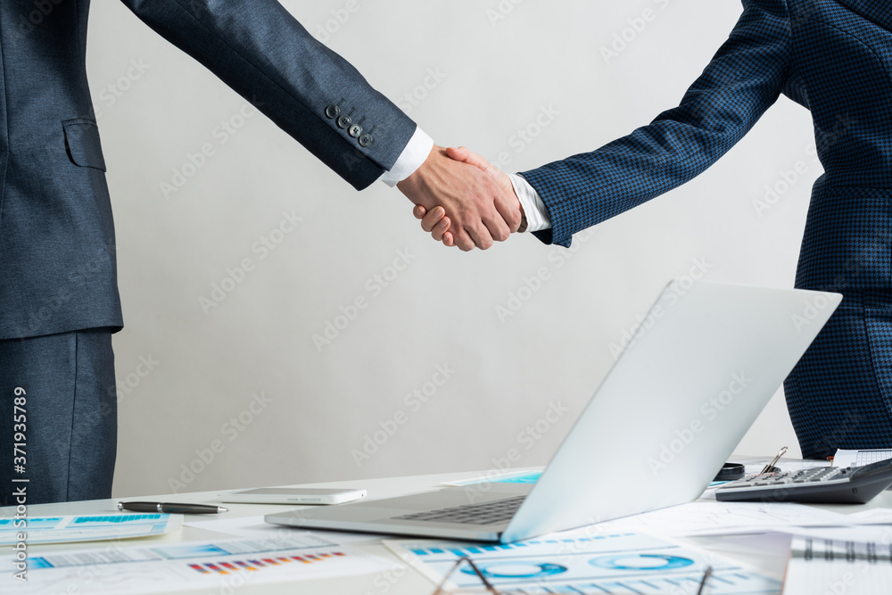 Businessman and woman handshaking after good deal