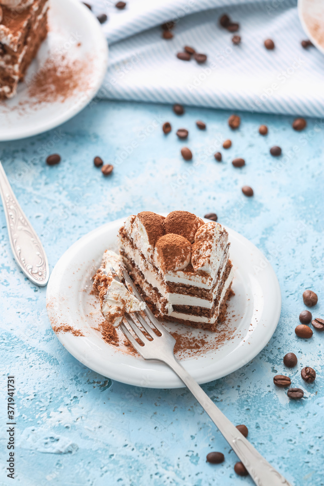 Plate with tasty tiramisu on color background