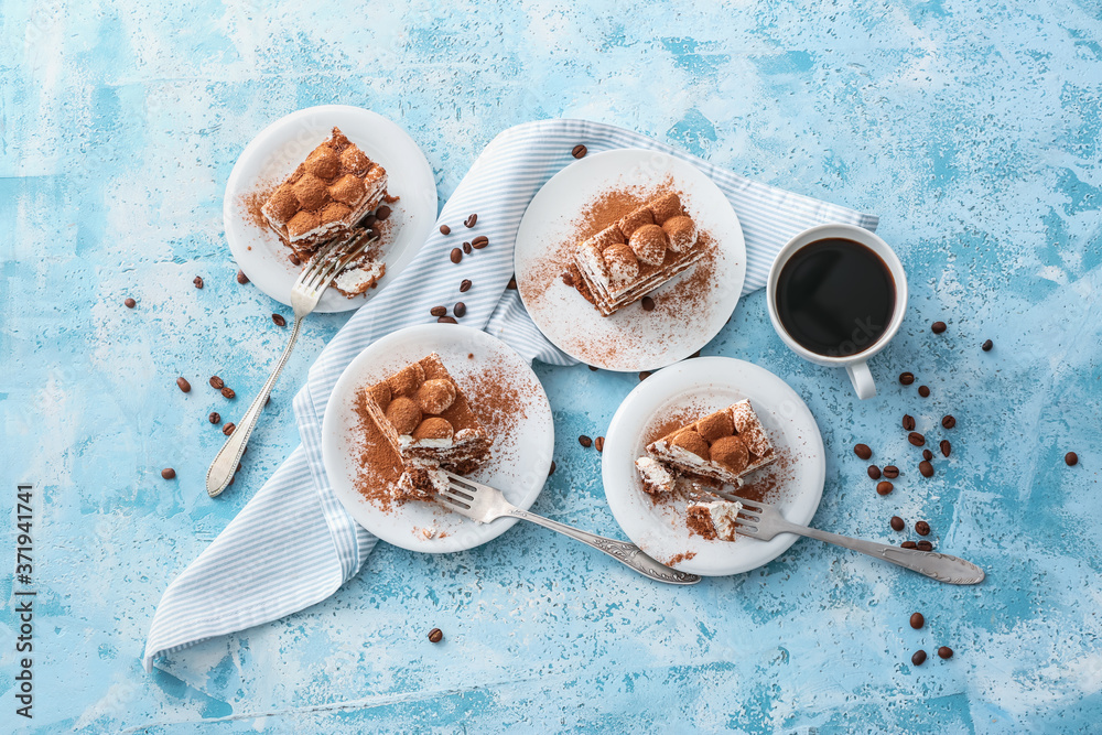 Plates with tasty tiramisu and coffee on color background