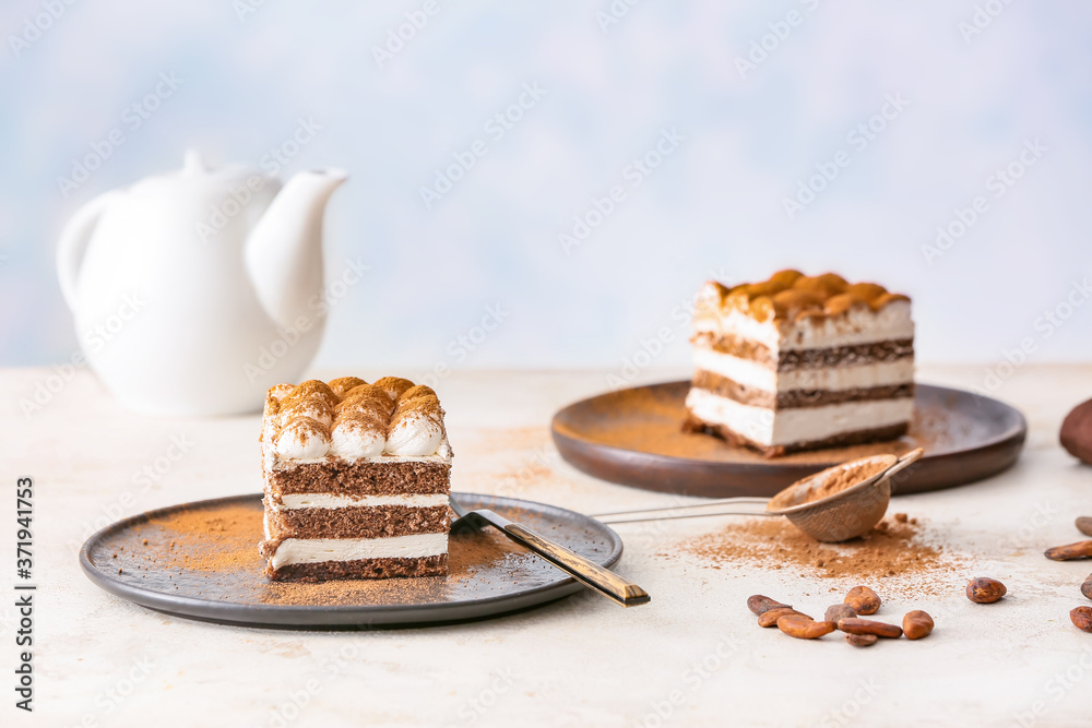 Plates with tasty tiramisu on table