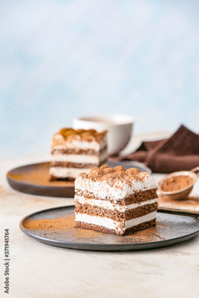 Plate with tasty tiramisu on table