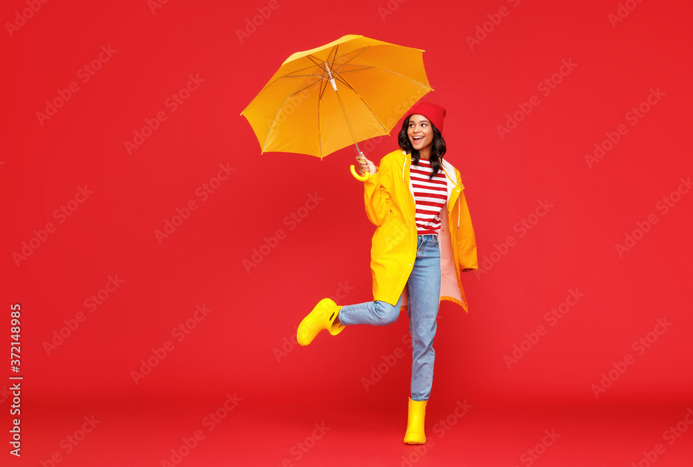 Happy ethnic female on rainy day