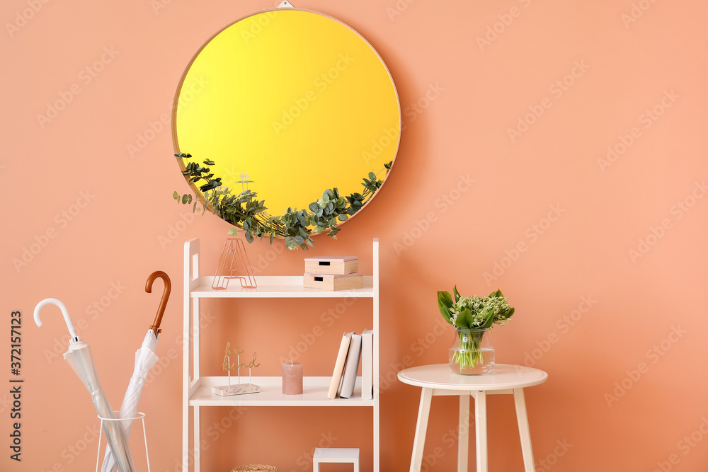 Interior of modern hallway with mirror and rack