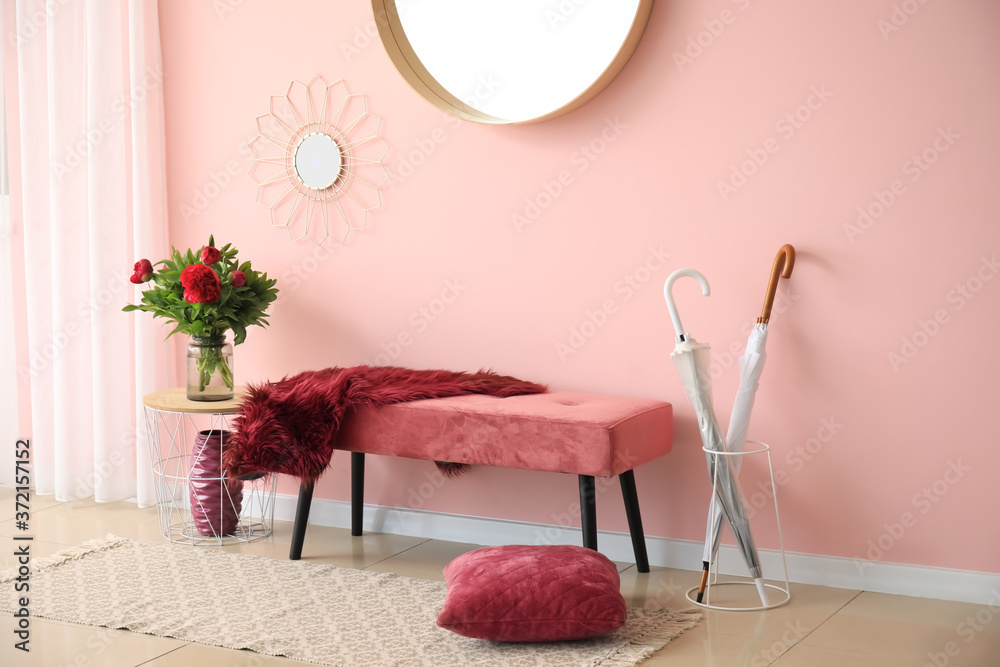 Interior of modern hallway with mirror and bench