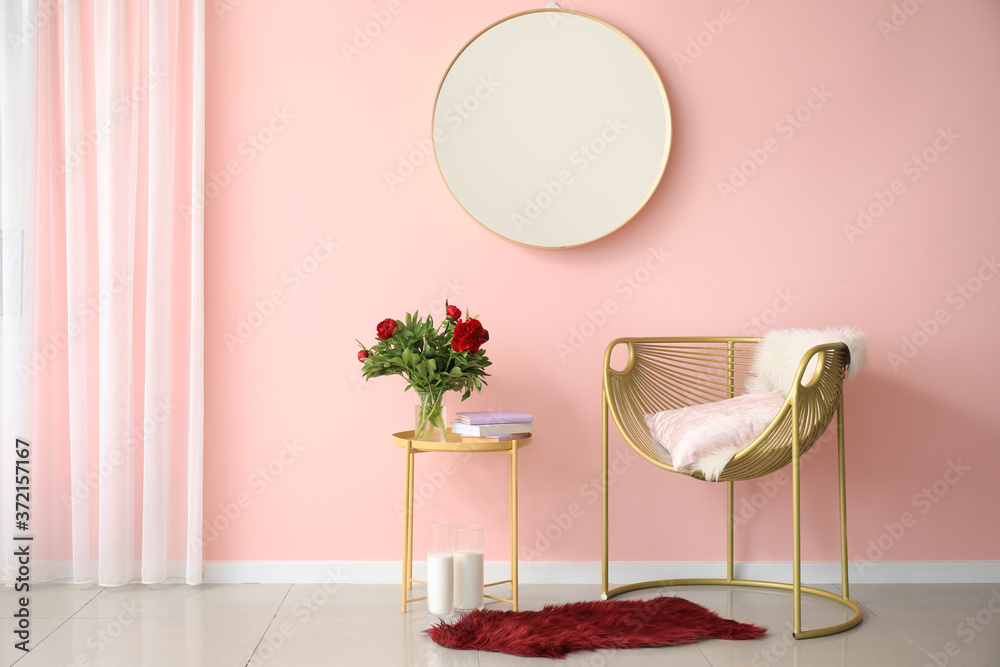 Interior of modern room with mirror, armchair and table