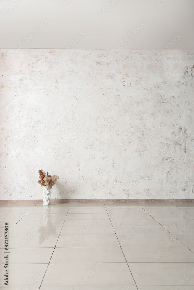 Vase with floral decor in empty room