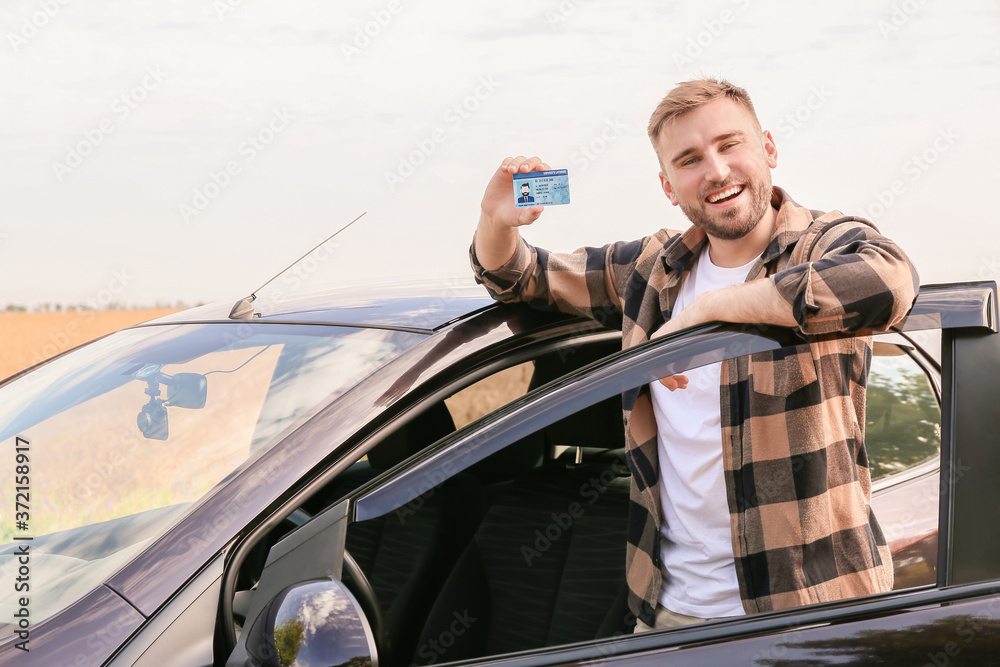 Happy young man after successful passing of driving license test