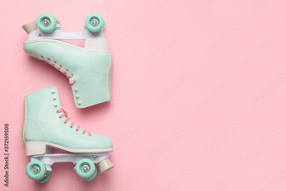 Roller skates on color background