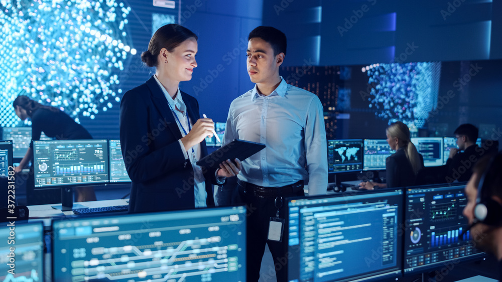 Project Manager and Computer Science Engineer Talking while Using A Digital Tablet Computer. Telecom