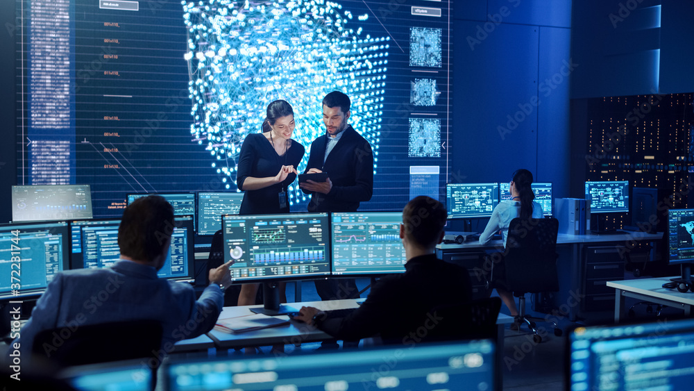 Project Manager and Computer Science Engineer Talking while Using A Digital Tablet Computer. Telecom