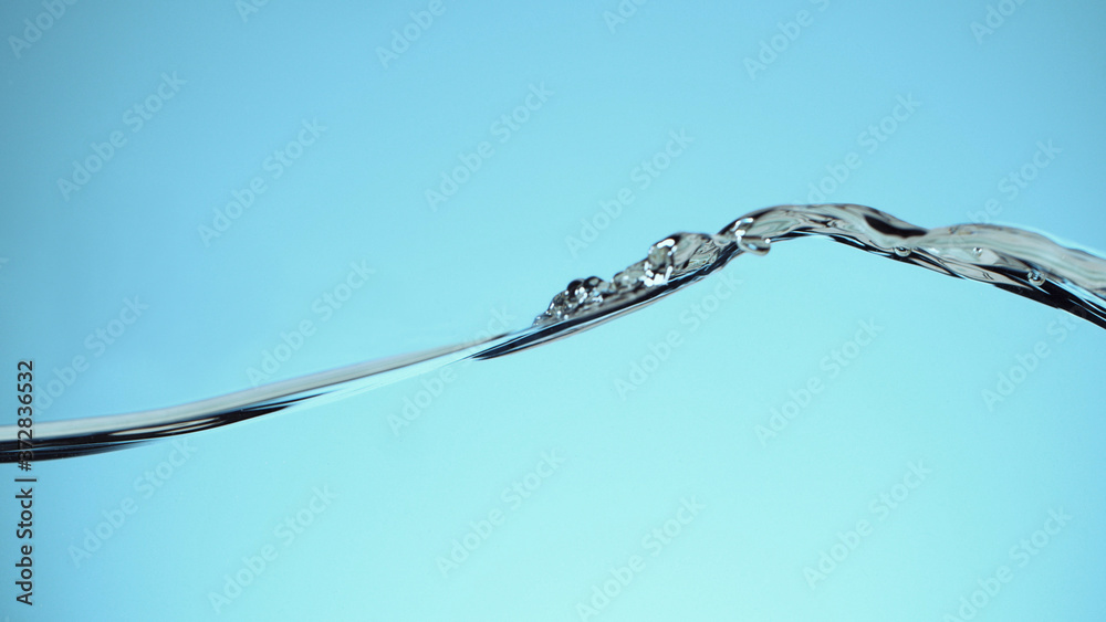 Closeup of water waves isolated on blue