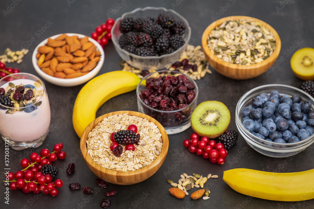 Fruits and Breakfast with Whole grains and nuts, yogurt mix with Cherry , banana, avocado in the woo