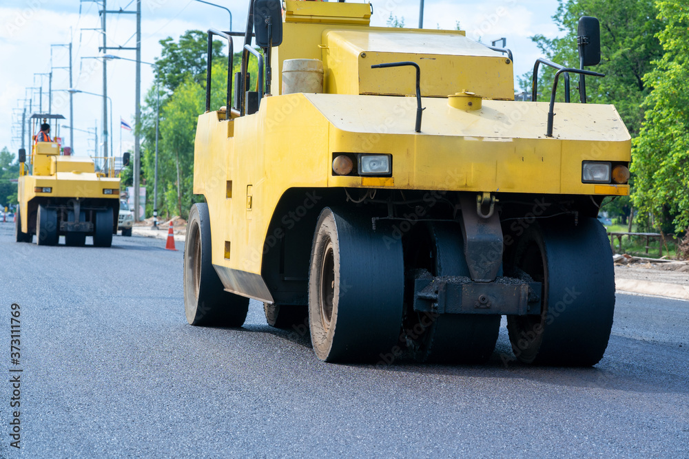 The road rollers working on the new road construction site at city.