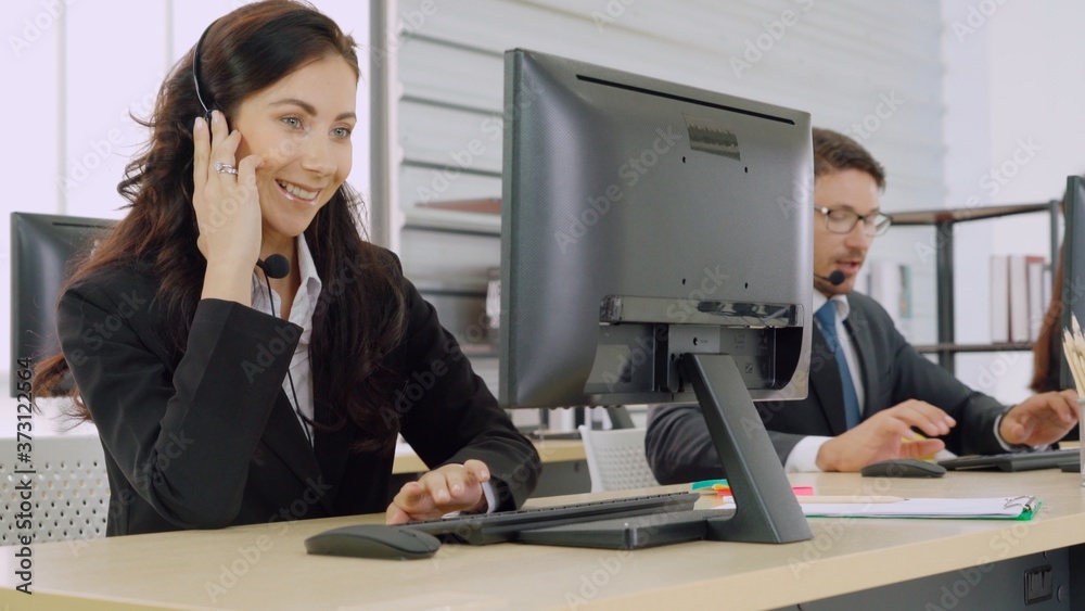 Business people wearing headset working in office to support remote customer or colleague. Call cent