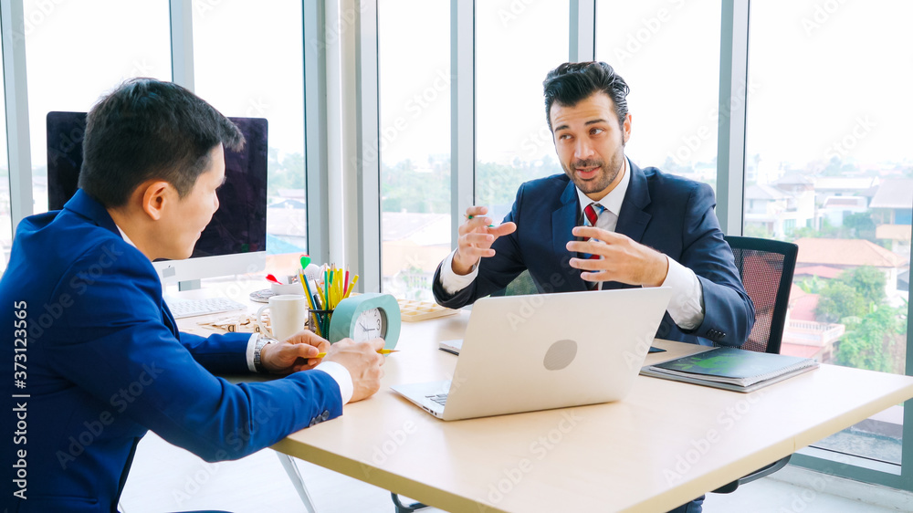 Two business people talk project strategy at office meeting room. Businessman discuss project planni