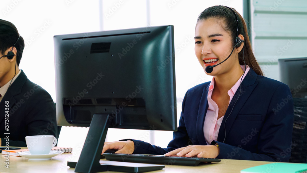 Business people wearing headset working in office to support remote customer or colleague. Call cent