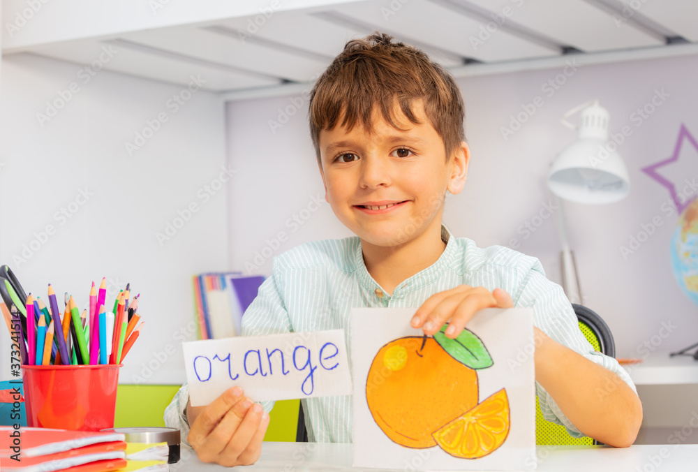 Positive boy in development class with word and object card during ABA therapy