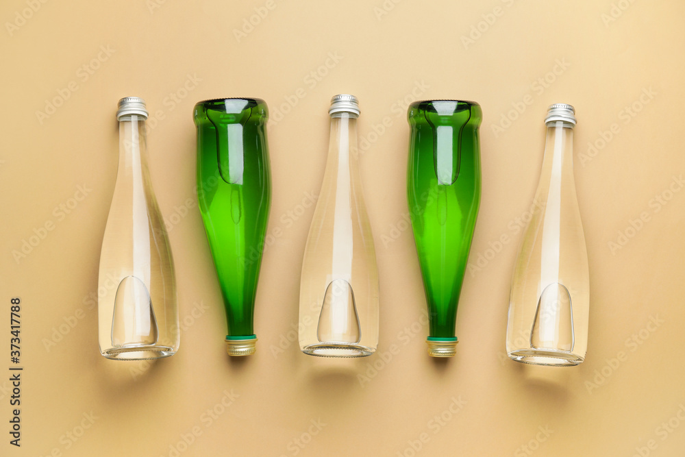 Bottles of clean water on color background