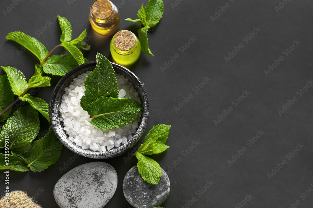 Spa composition with mint and sea salt on dark background