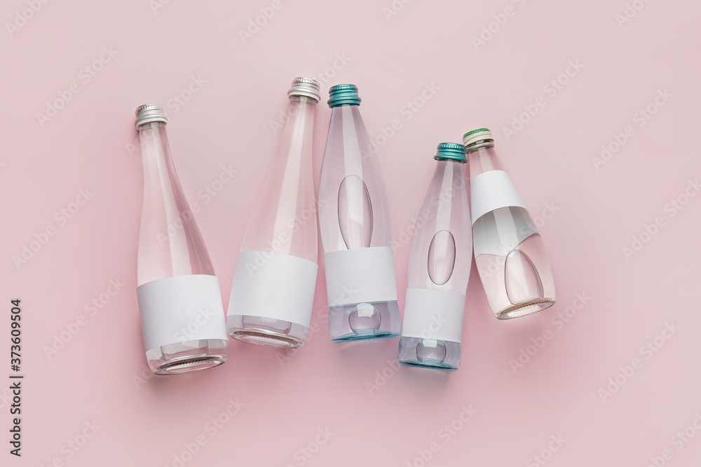 Bottles of clean water on color background