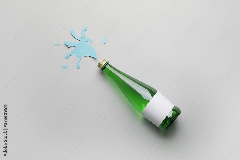 Bottle of clean water on light background