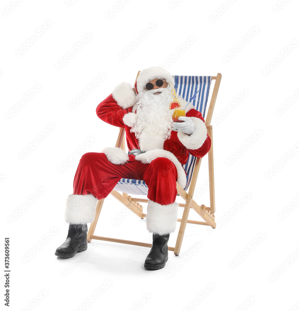 African-American Santa Claus sitting on sun lounger against white background