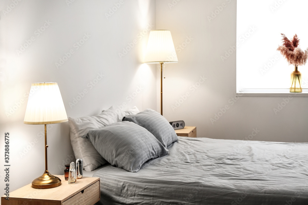 Interior of modern hotel room with glowing lamps