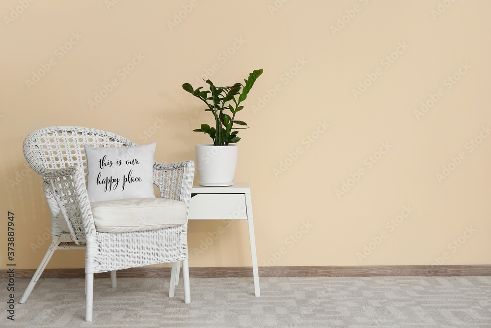 Stylish interior of living room with table and armchair