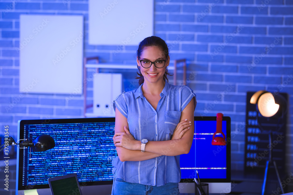 Female programmer in office at night