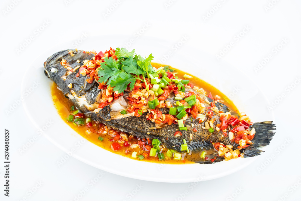 Braised grouper in a dish of Chinese cuisine on white background