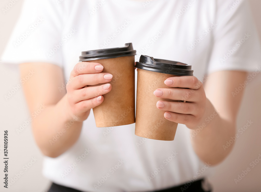 Woman with cups of hot coffee, closeup