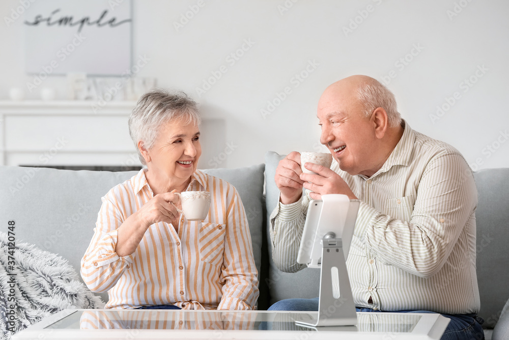 Senior couple drinking tea at home