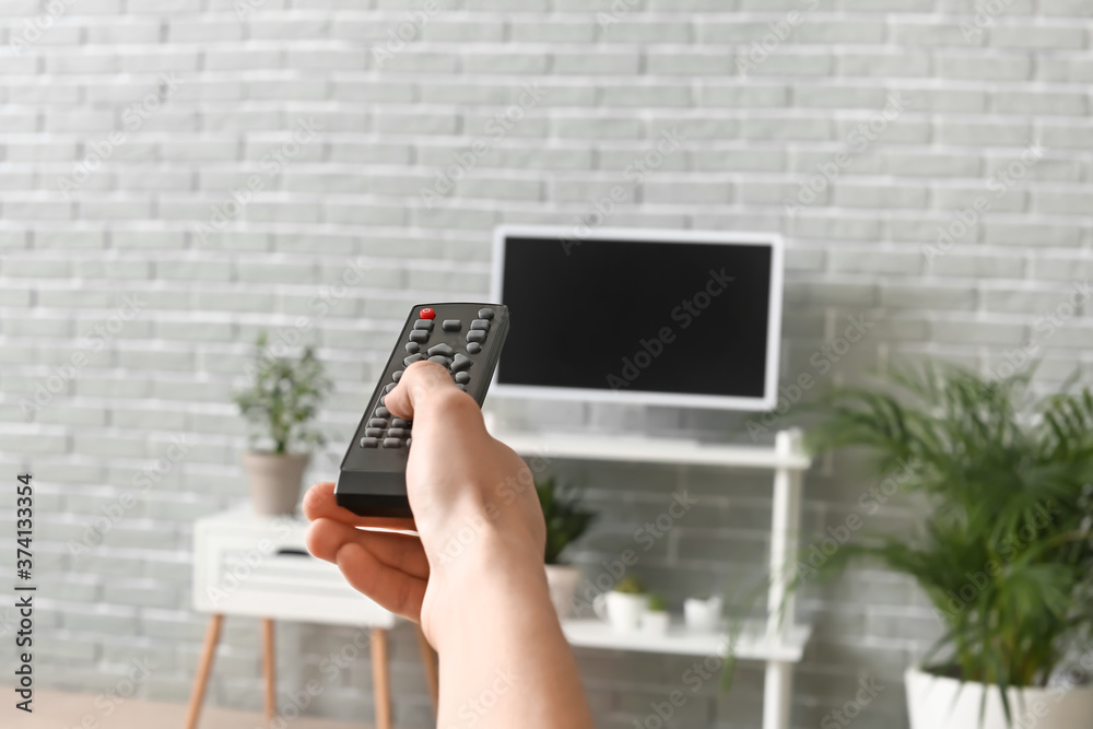 Young man watching TV at home