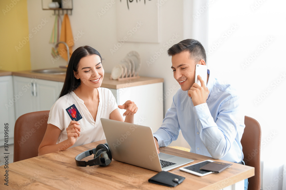 Young couple booking tickets online at home