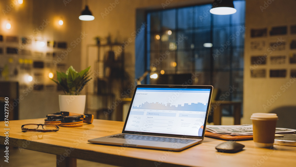 Laptop on the Desk in the Office Shows Company Growth Data with Graphs, Charts, Software UI. In the 