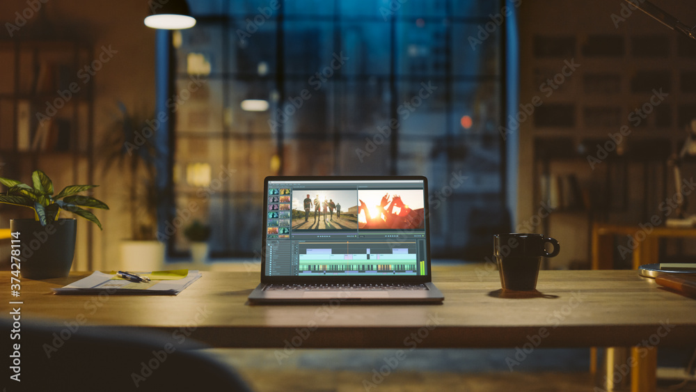 Shot of a Laptop Computer Standing on a Desk with Professional Video Montage Editing Software. In th