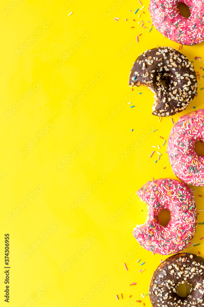 Top view of colorful glazed donut swith sprinkles, copy space