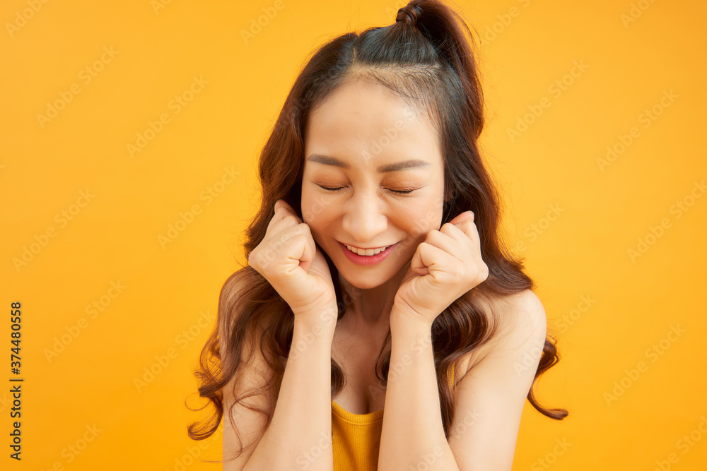 Happy woman Laughing. Cute girl in summertime isolated over orange background.