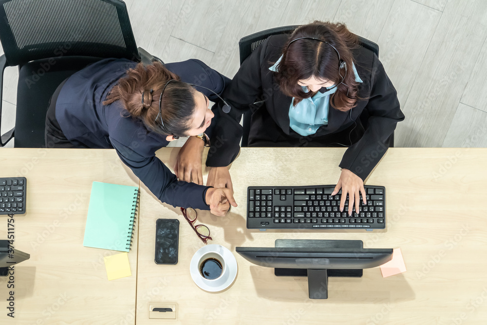 Business people wearing headset from top view in office working with computer to support remote cust