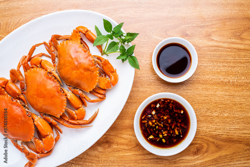 A dish of delicious steamed red sturgeon crab on wooden table