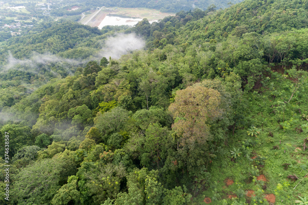 Aerial view drone shot of mountain tropical rainforest,Bird eye view image over the clouds Amazing n