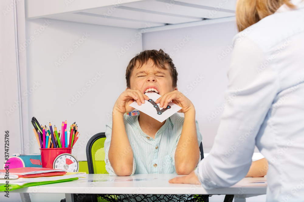 Autistic child bite card expressing negative emotions, throwing tantrums while learning numbers sitt