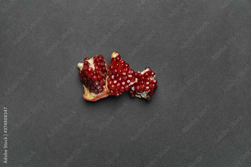 Pieces of fresh pomegranate on dark background