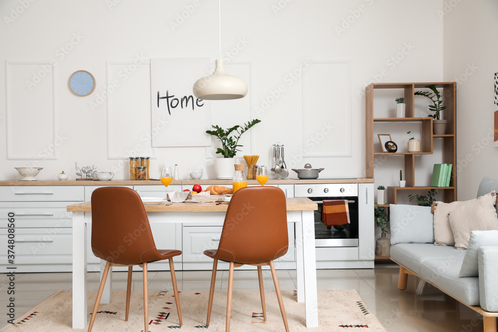 Interior of modern stylish kitchen with dining table