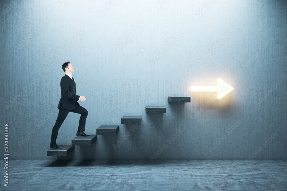 Businessman in suit moving up on stairs