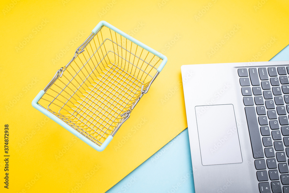 Laptop and shopping basket online shopping consumption concept illustration