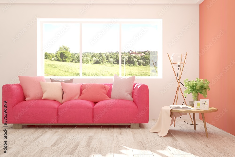 Coral stylish minimalist room with sofa and summer landscape in window. Scandinavian interior design